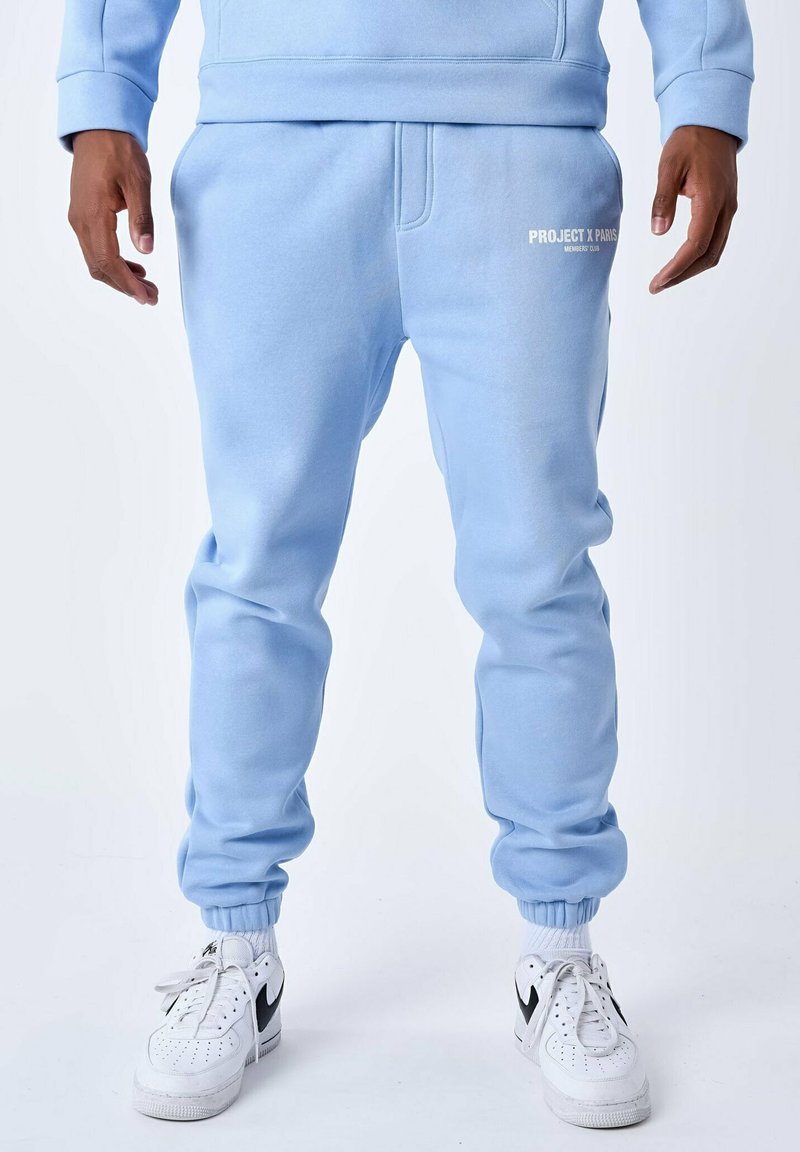 Lichtblauwe sweatpants met geribbelde boorden, voorzien van een klein wit "PROJECT X PARIS" logo op de bovenbeen. Gemaakt van zachte, gestructureerde stof.