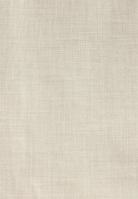 Texture de tissu tissé beige avec un motif quadrillé subtil créant une apparence naturelle rappelant le lin.
