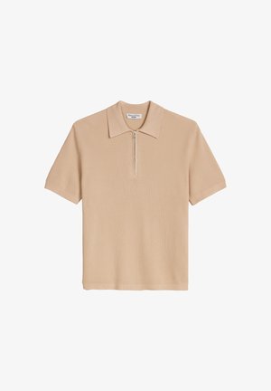 Beige ribbed short-sleeve polo shirt with a zippered collar and a small brand label inside the neckline.