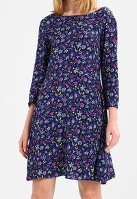 Navy blue dress with colorful floral patterns, three-quarter sleeves, a round neckline, and a flared silhouette. Made of soft fabric.
