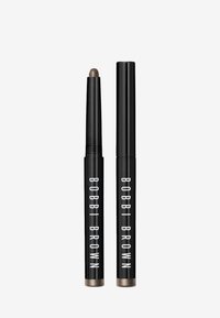 Bobbi Brown oogstift in zwarte verpakking met witte tekst. De punt is afgerond, met een metallic taupekleur. Inclusief twee applicators.
