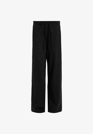 Schwarze Jogginghose mit lässigem Schnitt, elastischem Taillenbund und verstellbarem Kordelzug. Hergestellt aus einem weichen, strukturierten Stoff. Keine zusätzlichen Muster.