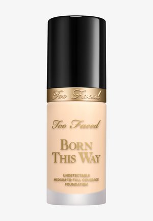 Too Faced Born This Way Foundation in einer mattierten Glasflasche mit mattschwarzem Deckel. Goldene Schrift auf der Vorderseite, leichtes Design, cremige Textur.