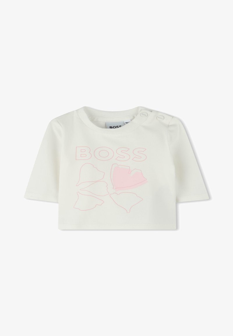 T-shirt blanc à manches courtes avec un col rond, arborant un graphique floral rose et le texte "BOSS". Boutons-pression à l'épaule pour un habillage facile.