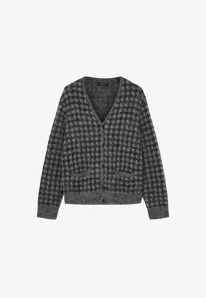 Grå hundetann cardigan med v-hals, lange ermer og lommer foran. Laget av myk, teksturert stoff med knappelukking.