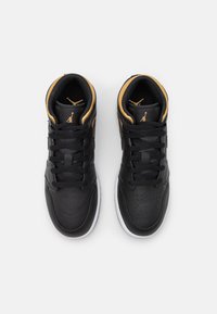 Czarne wysokie trampki z złotymi akcentami. Gładka skórzana cholewka, perforowany nos i biała gumowa podeszwa. Wyposażone w sznurówki i logo na języku.