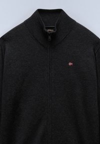 Dark gray zip-up sweater with ribbed collar and small embroidered Norwegian flag on left chest.