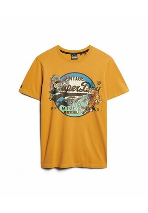Oranges Baumwoll-T-Shirt mit einem runden Vintage-Grafikdesign, das einen Drachen und einen Tiger zeigt. Mit kurzen Ärmeln und Rundhalsausschnitt.