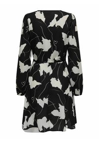 Robe noire avec motif floral abstrait blanc, manches bouffantes longues, taille à nouer et jupe fluide. Fabriquée en tissu léger et texturé.