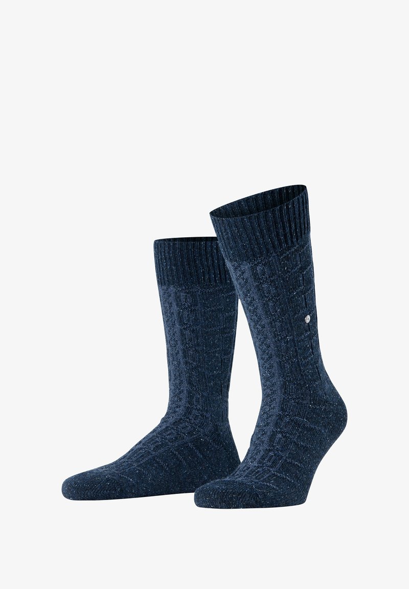 Granatowe getry robione na drutach z teksturowanym wzorem, ściągaczem i wzmocnioną piętą. Tkanina posiada drobne wtrącenia dla dodatkowego efektu wizualnego.