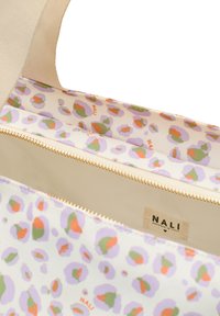 Yttre påse i krämfärgad tyg med en pastellfärgad leopardmönstrad foder. Har ett dubbelt fack med guldfärgade dragkedjor och en etikett som säger "NALI."