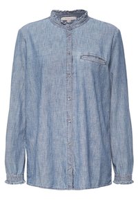 Camicia in chambray azzurro chiaro con colletto a stood, apertura frontale con bottoni e tasca sul petto. Maniche lunghe con polsini arricciati e una texture morbida.