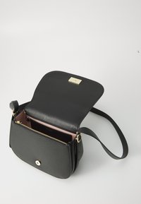 Black leather crossbody bag with a flap closure, gold hardware, and a pink interior. Features an external zip pocket and a shoulder strap.