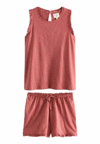 Vaateparin ruusupinkki pyjama. Yläosassa on avainreikämalli takana ja röyhelödet olkaimet. Shortseissa on joustava vyötärö ja röyhelöreunat.