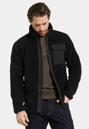 Black fleece jacket with a zip front, high collar, and chest pocket. Features a textured fabric and fitted cuffs for warmth.