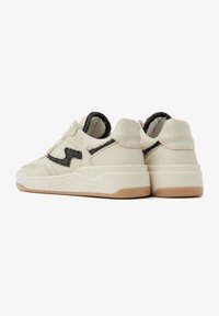 White leather sneakers with black accents, textured heel, and a chunky sole. Features logo branding and padded collar for comfort.