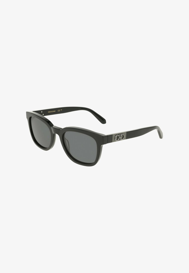 Black rectangular sunglasses with dark lenses, thick plastic frames, and silver logo detail on the side. Smooth texture throughout.