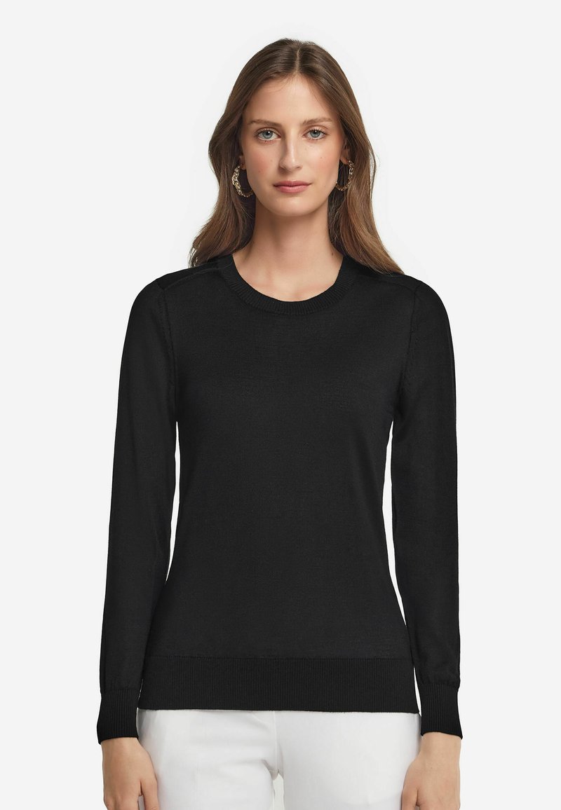 Schwarzer gestrickter Pullover mit langen Ärmeln, Rundhalsausschnitt, gerippten Bündchen und Saum. Verfügt über eine glatte Textur und ein schlichtes Design.