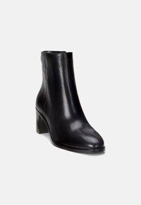 Černá kožená kotníková bota s hladkým povrchem, zaoblenou špičkou a středně vysokým blokovým podpatkem. Hladká textura, minimalistický design.