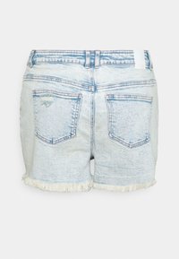 Vaaleansiniset denimhousut, joissa on rispaantunut helma, viiden taskun malli ja kulutetut yksityiskohdat takana. Vakiomallinen vyötärönauha.