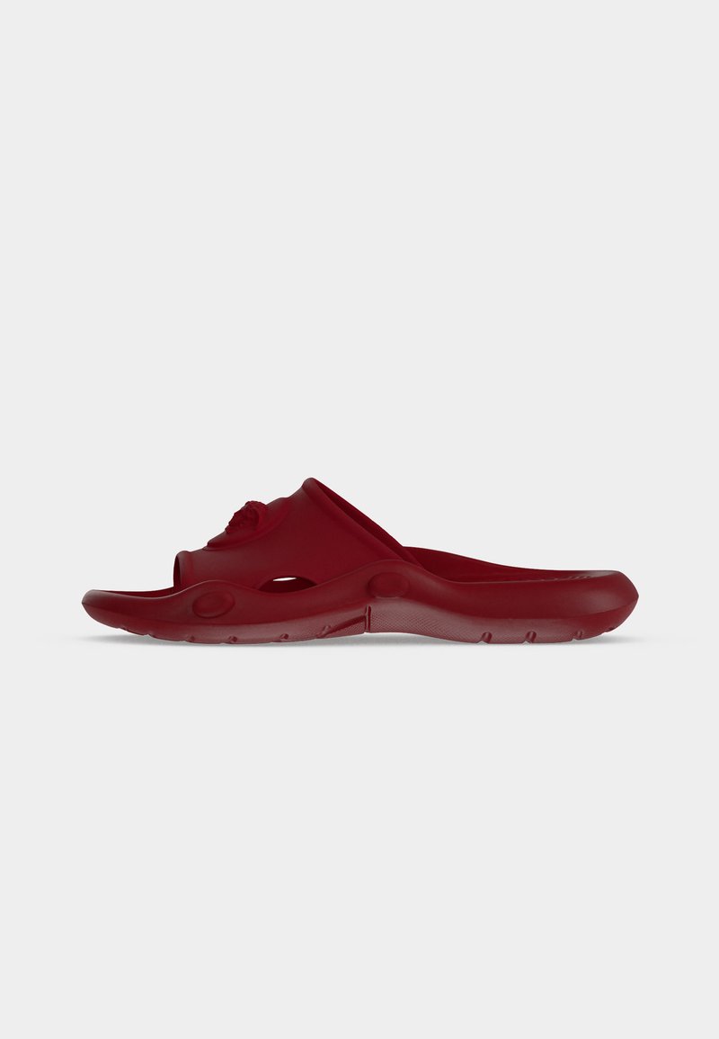 Red slip-on sandal with open toe, ventilated sides, and textured sole, shown in side profile on a plain white background.