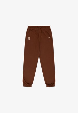 Pantalons de jogging marron en tissu doux, avec une taille élastique munie d'un cordon de serrage et des poignets fuselés. Affiche un logo en crème.