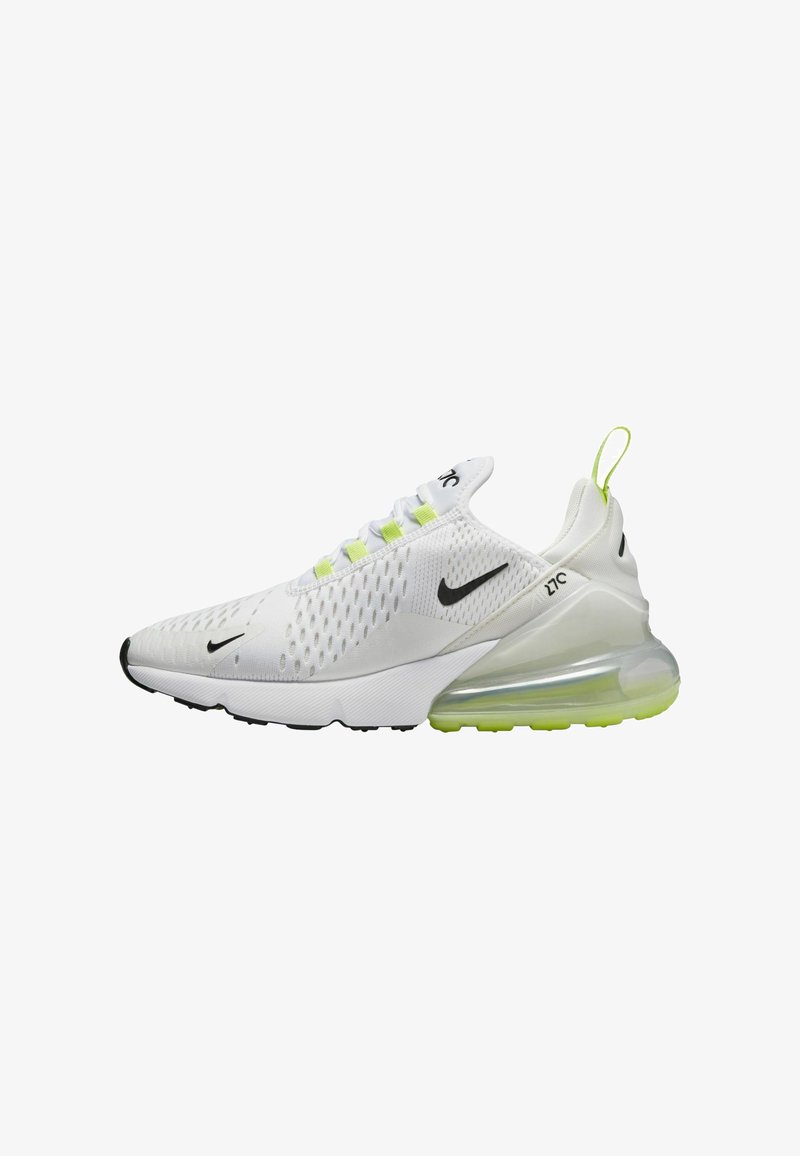 White athletic shoes with mesh upper, black Nike swoosh, bright green accents, and translucent air cushion midsole. Textured outsole for grip.