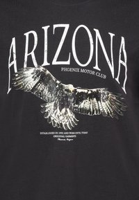 Black cotton t-shirt featuring a large, graphic eagle design with white text reading "ARIZONA PHOENIX MOTOR CLUB" above.
