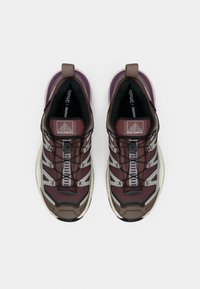 Μαραγκό κόκκινα και γκρι αθλητικά παπούτσια με υφή στο πάνω μέρος, που διαθέτουν ασφαλές σύστημα κορδονιών και αντανακλαστικές λεπτομέρειες σε λευκή σόλα.