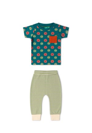 Short-sleeve teal toddler shirt with red and green apple prints and orange pocket, paired with green and white striped pants with beige cuffs.