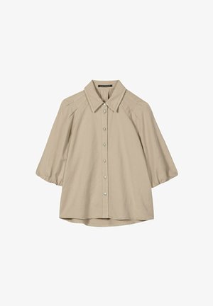 Beige three-quarter sleeve blouse with pointed collar and front button closure, made of lightweight fabric.