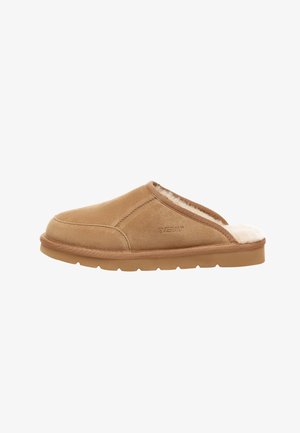 Tan suede slip-on slipper with a plush interior lining, round toe, and rubber sole. Features subtle stitched detailing along the edges.