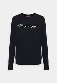 Felpa nera in cotone, con maniche lunghe, girocollo e logo "Tommy Hilfiger" ricamato in bianco sul petto.