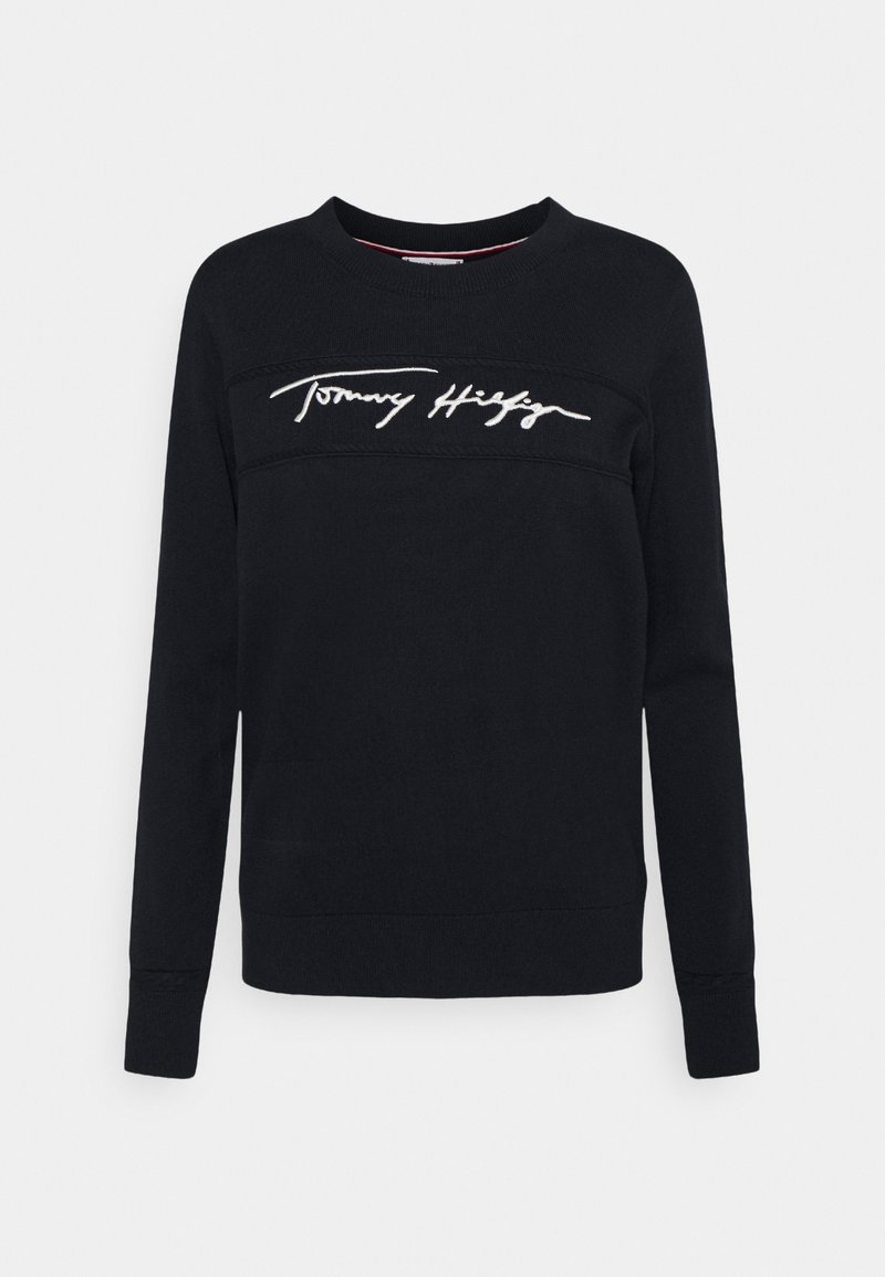 Svart sweatshirt i bomull, med långa ärmar, rundad halsringning och vitt broderat "Tommy Hilfiger"-logotyp över bröstet.