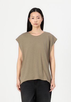 Olive green, short-sleeve t-shirt made of soft material, featuring a rounded neckline and relaxed, loose fit. Model wearing black pants.