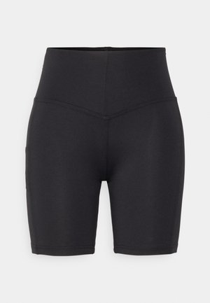 Shorts de vélo noirs taille haute en matériau extensible, avec une texture lisse et des coutures à plat, et un détail de poche sur le côté.