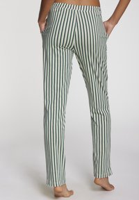 Striped pajama pants in green, cream, and navy. Features a fitted waistband and pockets, made from soft cotton material.
