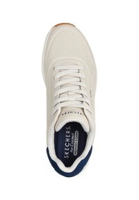 White perforated sneaker with lace closure, navy accents on the tongue and heel, and textured insole labeled "SKECHERS Air-Cooled Memory Foam."