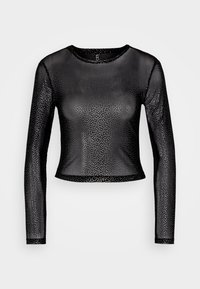Svart långärmad topp i genomskinligt material prydd med spridda silverprickar, med rund halsringning och kortad nederdel.