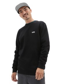 Czarna bluza z okrągłym dekoltem, długimi rękawami i małym białym logo Vans na piersi. Posiada ściągacze przy mankietach i na dole.