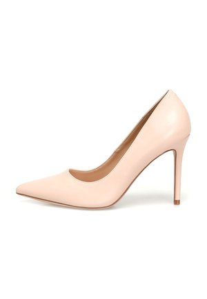 Nude patent leather high heel pump, pointed toe design, smooth texture, 4-inch stiletto heel, minimalistic style, inner lining visible.