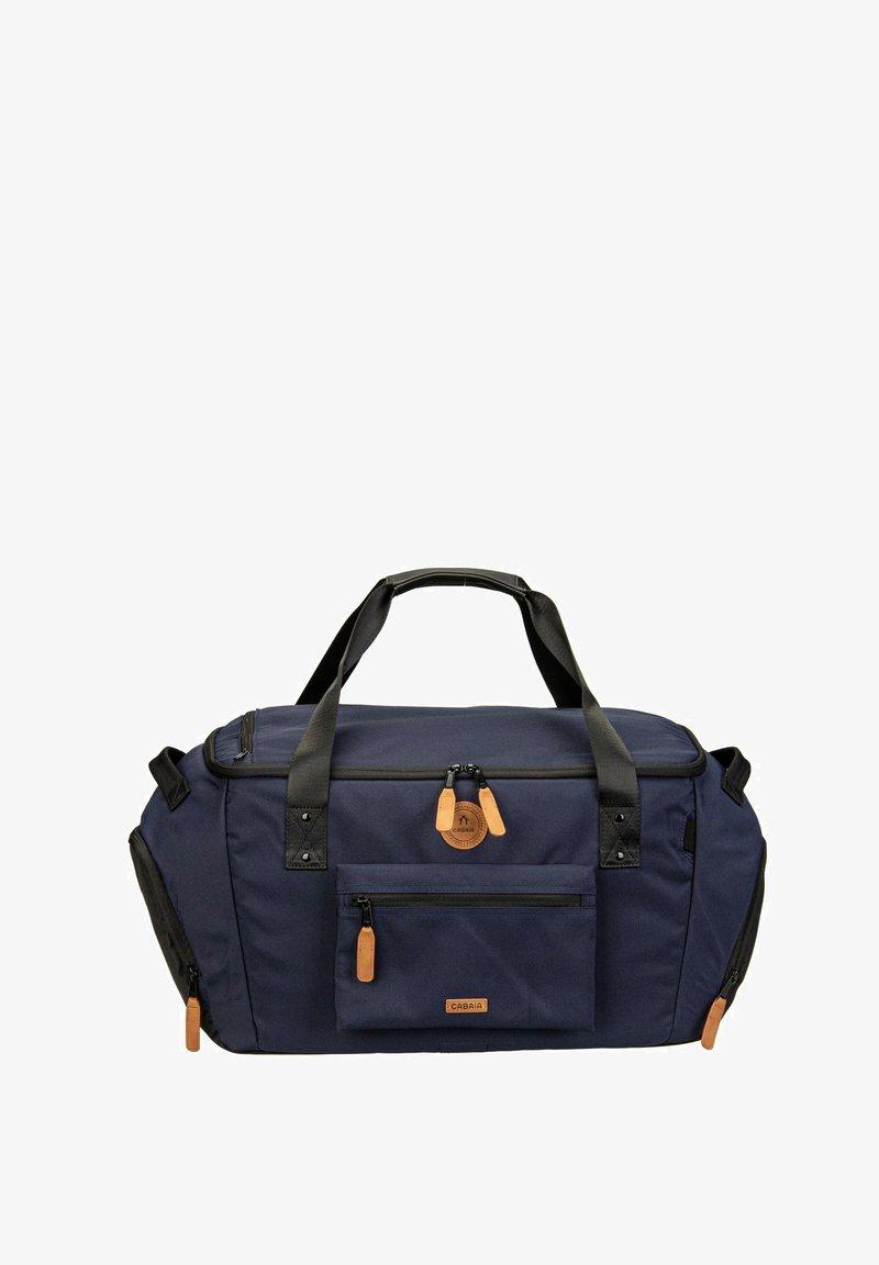 Sac de sport bleu marine avec poignées noires, tirettes de fermeture éclair marron, poche avant et compartiments latéraux zippés, conçu pour les voyages et l'utilisation en salle de sport.
