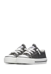 Czarne płócienne sneakersy niskie z białymi sznurówkami, gumowym noskiem, teksturowaną podeszwą i białymi przeszyciami po bokach oraz na języku.