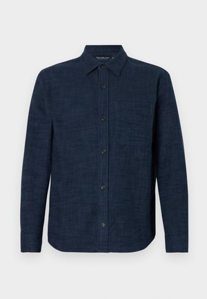 Dark blue long-sleeve linen shirt featuring a button-down front, single chest pocket, and a slightly curved hem. Textured fabric.