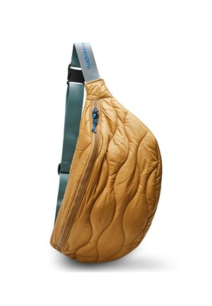 Quilted, mustard-colored sling bag with a curved shape. Features a blue zipper and a teal strap, offering a textured, insulated appearance.