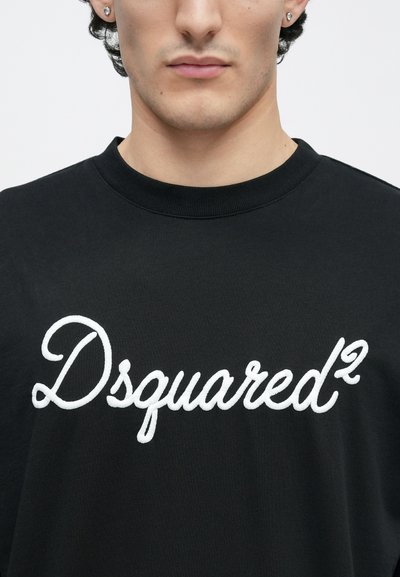 Black cotton sweatshirt featuring white embroidered "Dsquared²" logo, round neckline, and short sleeves. Smooth texture with a relaxed fit.