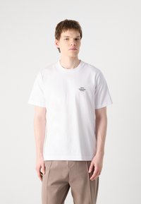 White cotton t-shirt with a crew neck and short sleeves, featuring a small black logo on the chest. Smooth texture, standard fit.