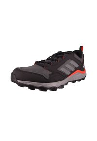 Black and gray athletic shoe with red accents, textured sole, lace-up design, and three gray stripes on the side.
