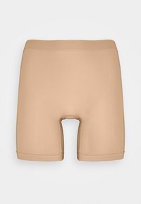 Beige compression shorts with smooth, stretchy fabric. Features a mid-length design and an opening at the center. Seamless edges.