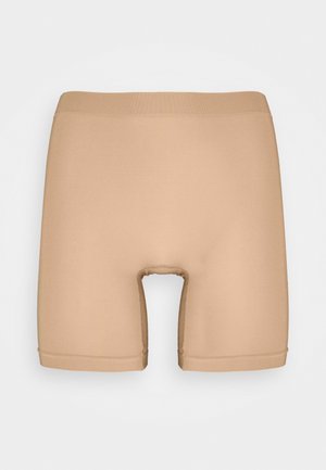 Beige kompressionsshorts i et glat, strækbart stof. Har et mellemlangt design og en åbning i midten. Sømløse kanter.